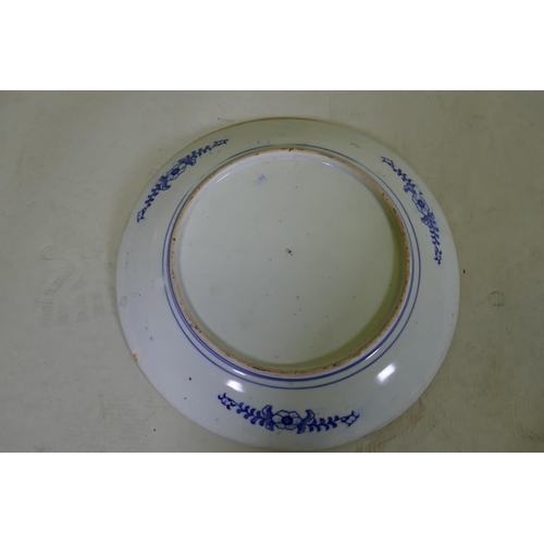 112 - A blue and white transfer printed dish with red rim and phoenix decoration, 30cm diameter