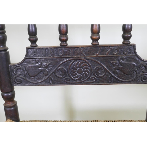 1128 - An C18th continental oak side chair, the back carved with a leaping stag and inscribed ANNO TK 1756,... 