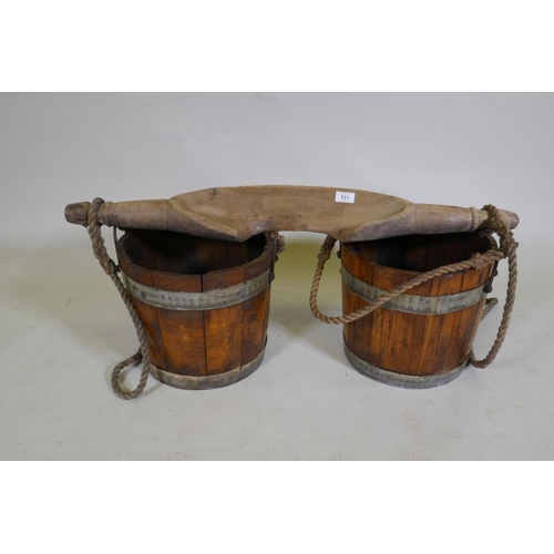 113 - An antique milk maids shoulder yoke and wood buckets, yoke 90cm long