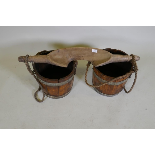 113 - An antique milk maids shoulder yoke and wood buckets, yoke 90cm long