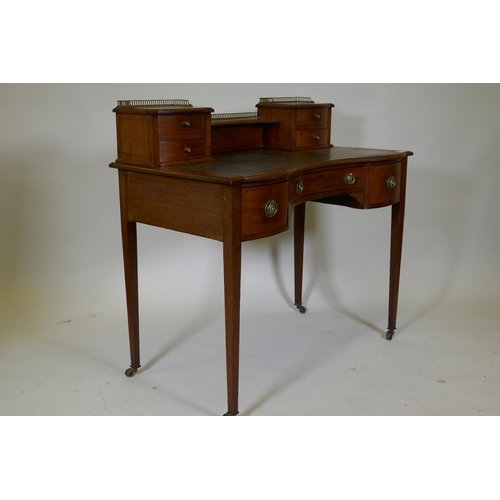 1138 - A Victorian inlaid mahogany bonheur de jour, the upper section with pierced brass gallery over four ... 