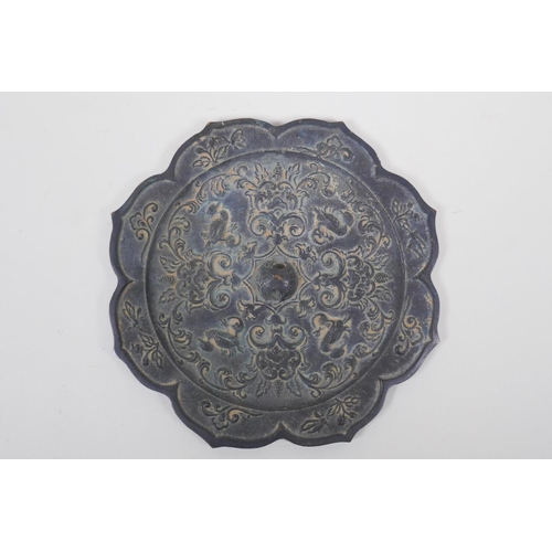 118 - A Chinese bronze lotus flower shaped mirror with raised duck and flower decoration, 21cm diameter