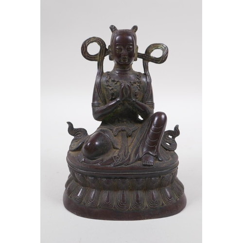 125 - A Sino Tibetan bronze of a deity in prayer, 16cm high