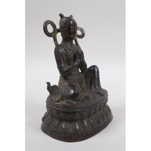 125 - A Sino Tibetan bronze of a deity in prayer, 16cm high