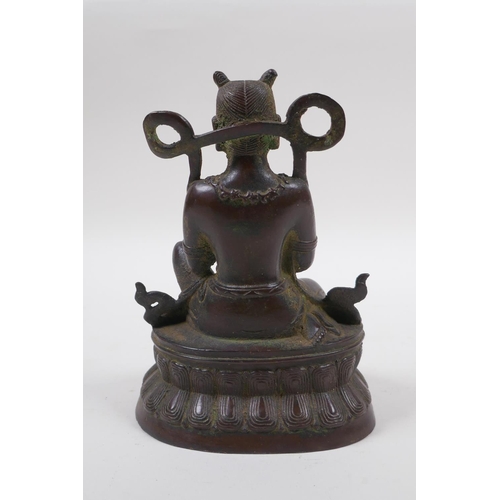 125 - A Sino Tibetan bronze of a deity in prayer, 16cm high