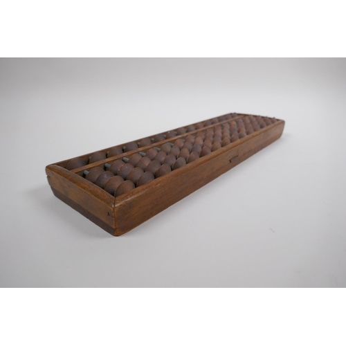 127 - A Chinese hardwood abacus with carved characters and inscription verso, 33 x 10cm