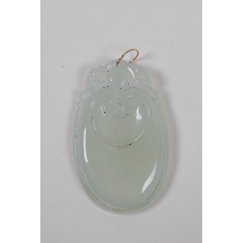 128 - A Chinese translucent hardstone pendant with carved ruyi decoration and a yellow metal loop, 3 x 5cm