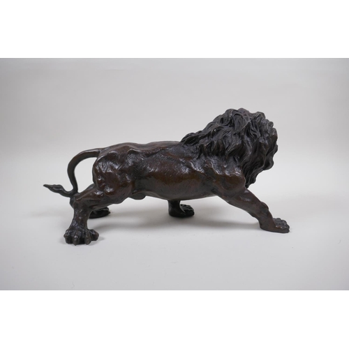 129 - After Rodin, a bronze figure of a prowling lion, 31cm long