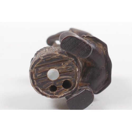 131 - A Japanese carved wood netsuke in the form of a man making mochi, 5cm high