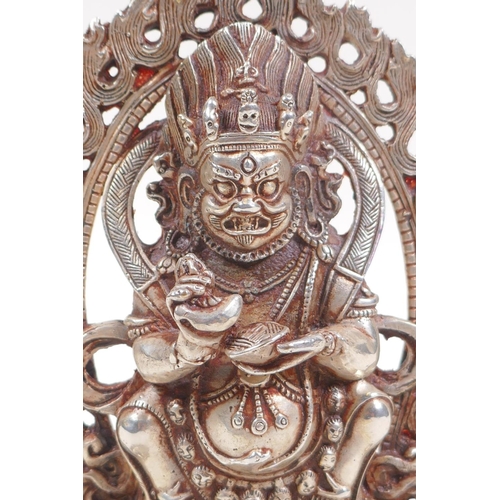 135 - A Sino Tibetan white metal figure of a wrathful deity, 16cm high