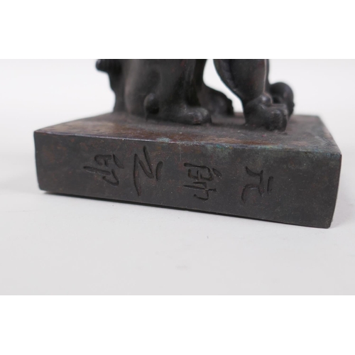 136 - A Chinese bronzed metal archaic style seal with kylin knop, 8 x 8cm