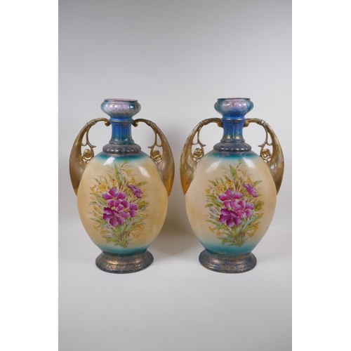 137 - A pair of Edwardian porcelain vases with gilt handles and floral decoration, 44cm high, AF