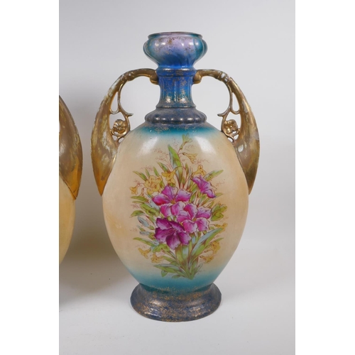 137 - A pair of Edwardian porcelain vases with gilt handles and floral decoration, 44cm high, AF