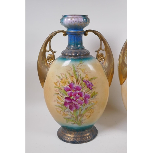 137 - A pair of Edwardian porcelain vases with gilt handles and floral decoration, 44cm high, AF