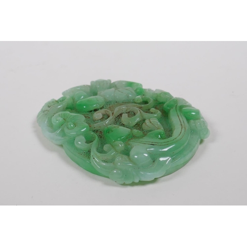 138 - A Chinese mottled green jade pendant with carved kylin, ruyi and bat decoration, 7 x 9cm