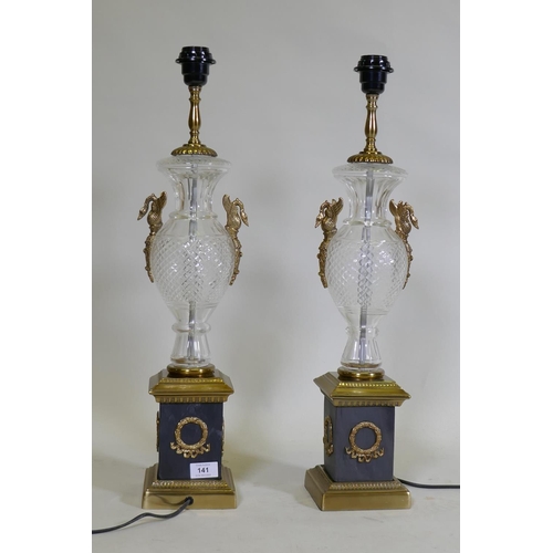 141 - A pair of glass and brass table lamps, with Empire style decoration, 64cm high