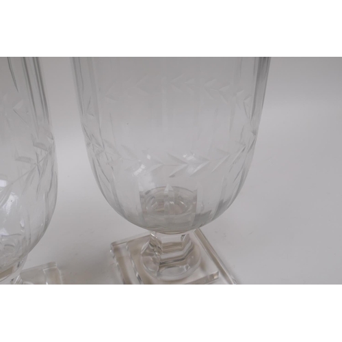 142 - A pair of glass hurricane vases with cut glass decoration, 34cm high, 12cm high