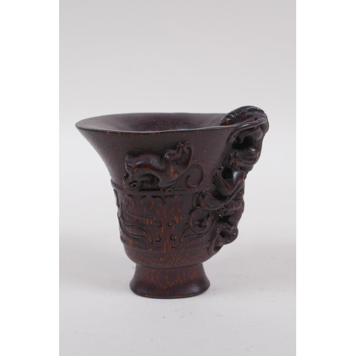 146 - A Chinese faux horn bamboo libation cup, with kylin decoration, seal mark to base, 8cm high