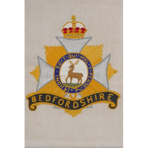 152 - A 1919 hand embroidery of the Bedfordshire Regimental badge/coat of arms, in a period frame, 36 x 43... 