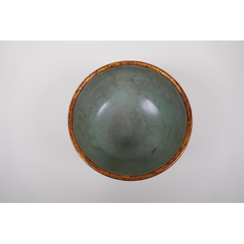 153 - A Chinese celadon crackle glazed porcelain bowl with a gilt metal rim and foot, the sides with chase... 