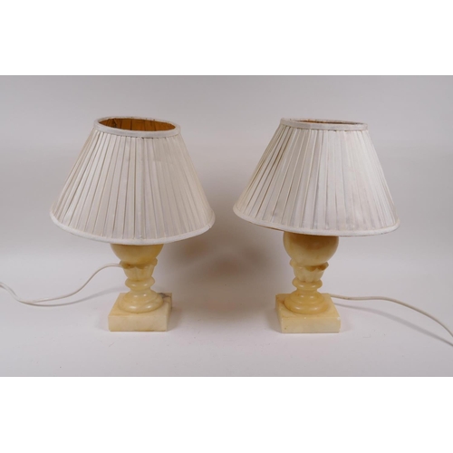 154 - A pair of carved alabaster lamps, with shades, 28cm high