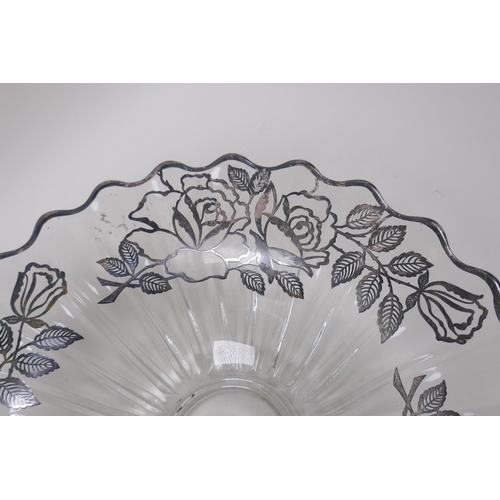 156 - A silver overlaid glass fruit bowl decorated with a rose design, 32cm diameter