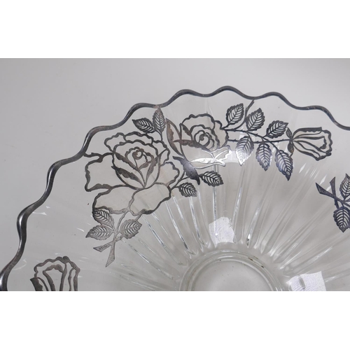 156 - A silver overlaid glass fruit bowl decorated with a rose design, 32cm diameter