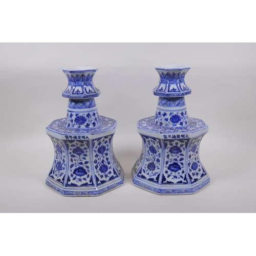 162 - A pair of blue and white porcelain candlesticks of octagonal form with decorative floral panels, Chi... 