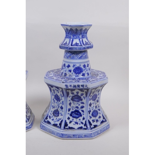 162 - A pair of blue and white porcelain candlesticks of octagonal form with decorative floral panels, Chi... 