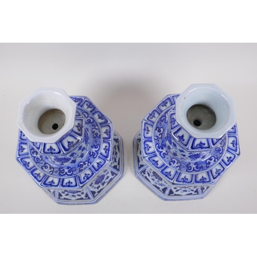 162 - A pair of blue and white porcelain candlesticks of octagonal form with decorative floral panels, Chi... 