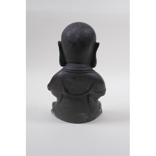 165 - A Chinese bronze figure of a buddha with oversized head, at prayer, 20cm high