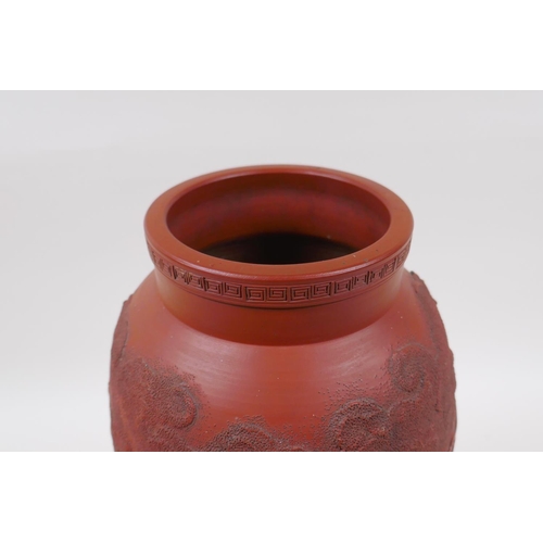 166 - A Japanese redware vase with raised dragon decoration, impressed mark to base, 30cm high