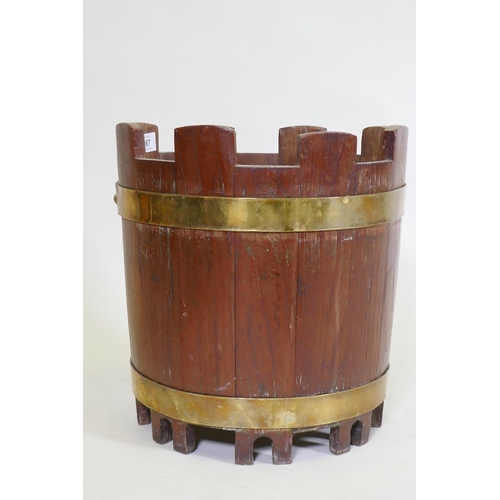 167 - A brass bound teak bucket with castellated top, 34cm high