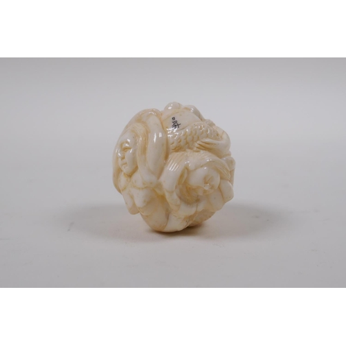 172 - A Japanese bone ball weight with carved mermaid decoration 3cm diameter