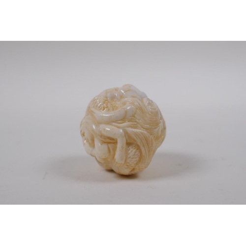 172 - A Japanese bone ball weight with carved mermaid decoration 3cm diameter