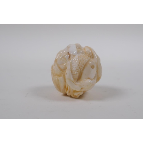 172 - A Japanese bone ball weight with carved mermaid decoration 3cm diameter