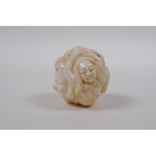 172 - A Japanese bone ball weight with carved mermaid decoration 3cm diameter