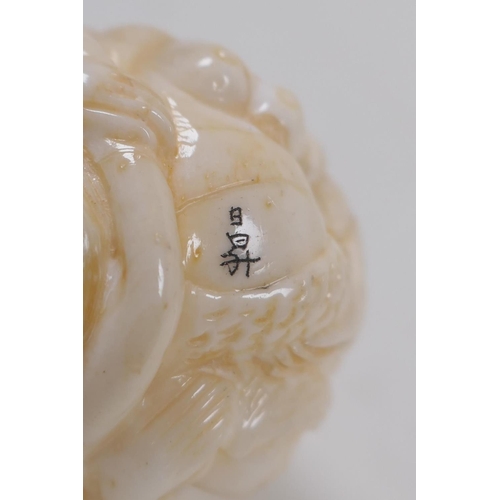 172 - A Japanese bone ball weight with carved mermaid decoration 3cm diameter