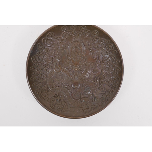 176 - A Chinese bronze trinket dish with raised dragon and flaming pearl decoration, impressed 4 character... 