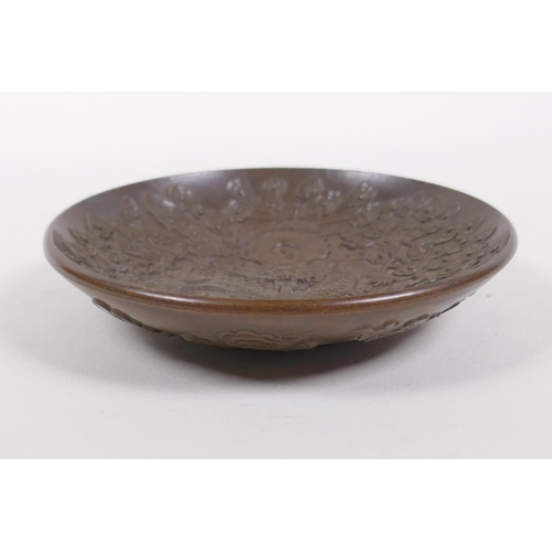 176 - A Chinese bronze trinket dish with raised dragon and flaming pearl decoration, impressed 4 character... 