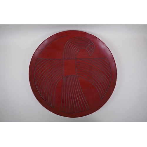 18 - A Chinese red Tixi lacquer charger with stylised bird decoration, Xuande 4 character mark to base, 4... 