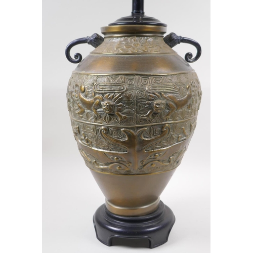 181 - A Chinese brass two handled vase with archaic style kylin decoration, converted to a lamp, 50cm high