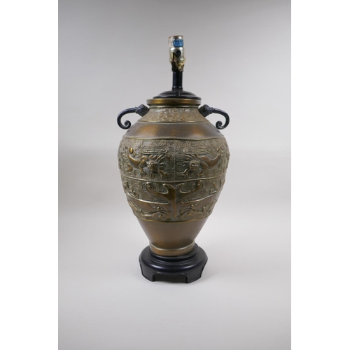 181 - A Chinese brass two handled vase with archaic style kylin decoration, converted to a lamp, 50cm high