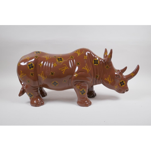 182 - A painted composition rhino with LV style decoration, 52cm long