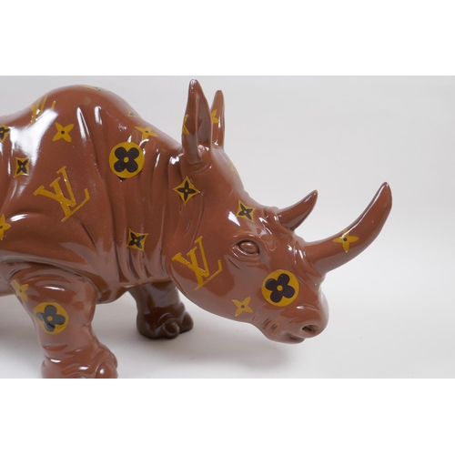 182 - A painted composition rhino with LV style decoration, 52cm long