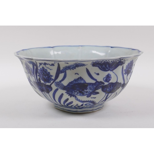 198 - A blue and white porcelain bowl of lobed form, decorated with carp in a lotus pond, Chinese Xuande 6... 