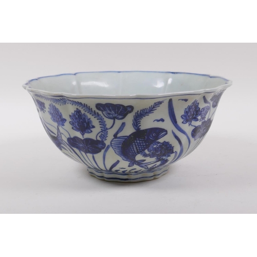 198 - A blue and white porcelain bowl of lobed form, decorated with carp in a lotus pond, Chinese Xuande 6... 