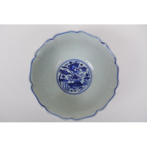 198 - A blue and white porcelain bowl of lobed form, decorated with carp in a lotus pond, Chinese Xuande 6... 