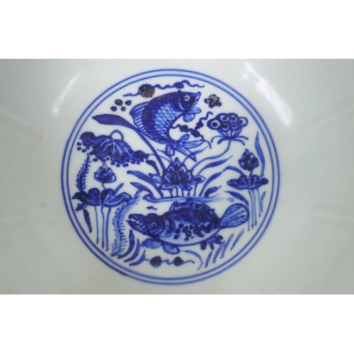 198 - A blue and white porcelain bowl of lobed form, decorated with carp in a lotus pond, Chinese Xuande 6... 