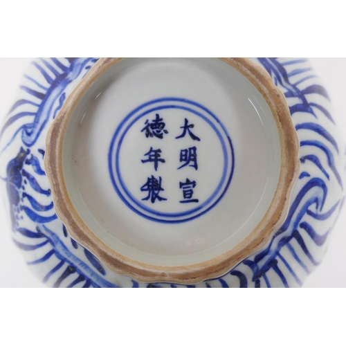 198 - A blue and white porcelain bowl of lobed form, decorated with carp in a lotus pond, Chinese Xuande 6... 